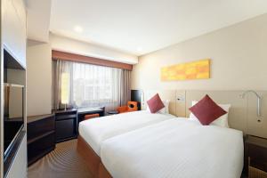 Postel nebo postele na pokoji v ubytování Hotel JAL City Kannai Yokohama