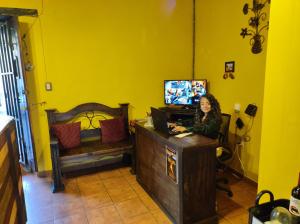 a woman sitting at a desk with a laptop at Hotel Casa Nikté in Antigua Guatemala