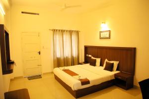 a bedroom with a large bed in a room at Highrange Plaza in Thekkady