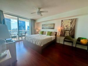 a bedroom with a bed and a balcony at Brickell Miami Unit, Amazing view, balcony, Pool, 1 free Parking in Miami +68 photos