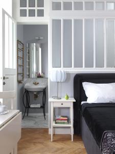a bedroom with a bed and a bathroom with a sink at Warsaw Concept in Warsaw