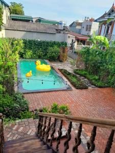 a swimming pool with two rubber ducks in it at 1989 Villa in Việt Trì