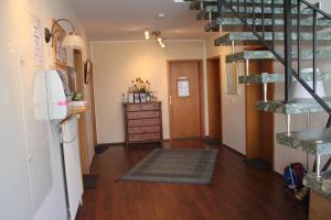 a hallway with a staircase and a room with a dresser at Apartmenthaus Padua in Büsum