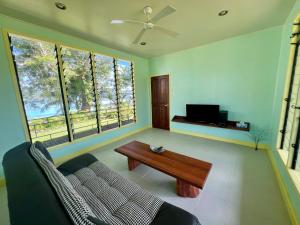 a living room with a couch and a coffee table at Lapita Beach Aore Island Vanuatu in Luganville