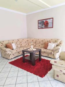 a living room with a couch and a table at Sunny City House Dunaújváros in Dunaújváros