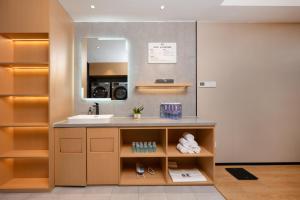 a bathroom with a sink and a mirror at True Go Hotel - Shenzhen Futian Huaqiang North in Shenzhen +52 photos