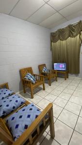 a room with two beds and a flat screen tv at Apartamento dos habitaciones in Mexicanos
