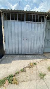 a large metal garage door on a house at Apartamento dos habitaciones in Mexicanos