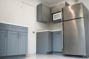 a kitchen with a stainless steel refrigerator and cabinets at Comfy studio in Dania Beach