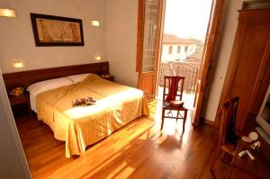 Postel nebo postele na pokoji v ubytování Hotel Palazzo Vecchio