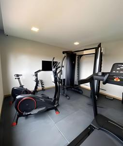 a gym with two exercise bikes and a treadmill at H.E 301 · Lindo Apt com Varanda - Caminho das árvores in Salvador