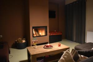 a living room with a coffee table and a fireplace at The Black Chestnut in Áyios Nikólaos +12 photos