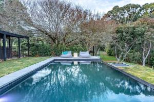 a swimming pool in a yard with two pillows on it at Winifred in Red Hill South