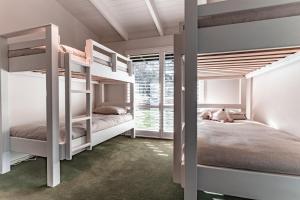 a bedroom with two bunk beds and a window at Winifred in Red Hill South
