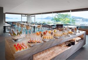 a buffet line with appetizers and desserts in a restaurant at Toba International Hotel in Toba