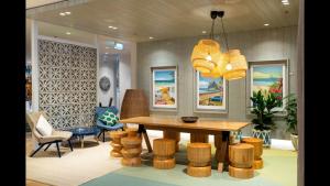 a dining room with a table and chairs and a chandelier at Holiday Inn Auckland Airport by IHG in Auckland