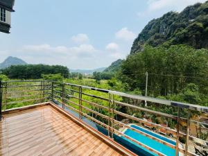 a balcony with a view of the mountains at Phong Nha Moonlight Villas in Phong Nha