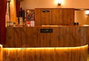 a wooden counter in a store with a sign on it at Kumaon Roop Resort Near Neem Karoli Temple in Nainital