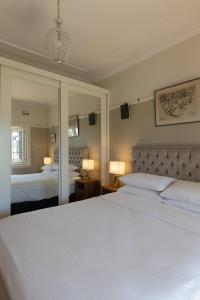 a bedroom with two beds and a large mirror at Bronte Boho Chic near Ocean with Parking in Sydney