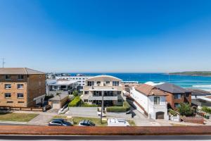 a view of the ocean from the balcony of a house at Stunning Maroubra Beachview Apt with Parking in Sydney
