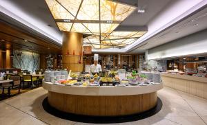 a buffet line with food on display in a restaurant at Centara Grand at Central Plaza Ladprao Bangkok in Bangkok