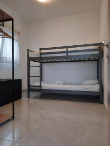 sypialnia z 2 łóżkami piętrowymi w pokoju w obiekcie By the sea w mieście Perea