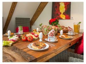 a wooden table with plates of food on it at Romantic maisonette in Schonach