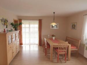 a kitchen with a table and chairs and a dining room at Schellenberg Modern retreat in Deggendorf