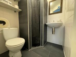 a bathroom with a toilet and a sink at Beach Apartment in Vlissingen
