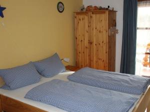 a bed with two blue pillows in a bedroom at Barbara Hintermair in Bischofsmais