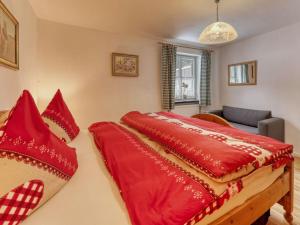 two red pillows on a bed in a room at Waldhaus Sonnenberg Apartment 1 in Drachselsried
