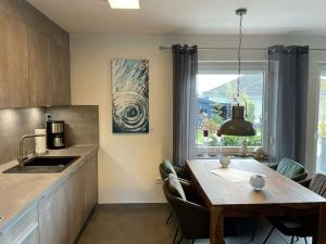 a kitchen with a table and a dining room at Lovely holiday home with sauna in Hooksiel