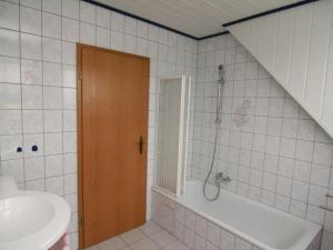 a bathroom with a shower and a tub and a sink at Am Turm Modern retreat in Mellrichstadt +31 photos