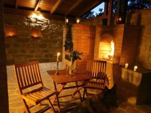 a patio with a table and two chairs and a fireplace at Am Turm Modern retreat in Mellrichstadt