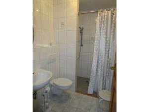 a bathroom with a sink and a toilet and a shower at Breitenbach Modern retreat in Harbshausen