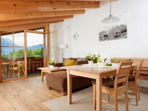 a living room with a wooden table and a couch at Oberstdorf dream view - Alpine star in Oberstdorf