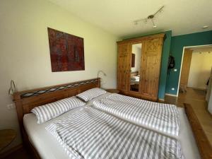 a bedroom with a large bed with two pillows at Hochgrat view in Steibis, Haus Akelei in Steibis