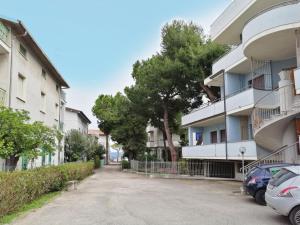 an apartment building with cars parked in a parking lot at HoliHome_La Sirena 50m dal Mare in Tortoreto Lido