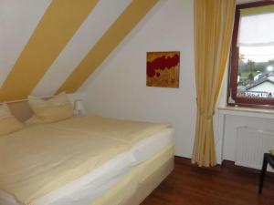 a bed in a room with a window and a bed sqor at "Weserbergland" Modern retreat in Beverungen