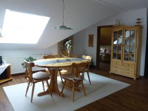 a dining room with a wooden table and chairs at "Weserbergland" Modern retreat in Beverungen