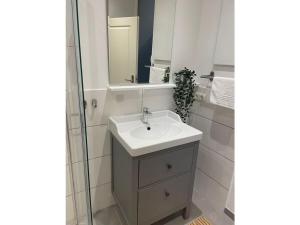 a bathroom with a sink and a mirror at Amazing holiday home near the lake in Hambühren
