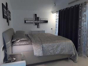 a bedroom with a bed and a cross on the wall at Holiday home with a roofed terrace in Morro del Jable