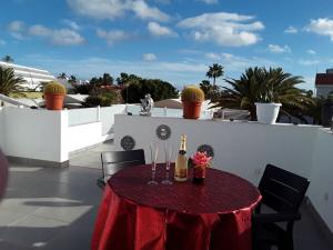 a table with a bottle of champagne on a roof at Holiday home with a roofed terrace in Morro del Jable
