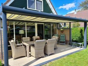 a patio with wicker chairs and a table at Sunshine Comfortable holiday residence in Sint Maarten