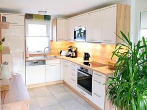 a kitchen with white cabinets and a wooden counter top at Sunshine Comfortable holiday residence in Sint Maarten