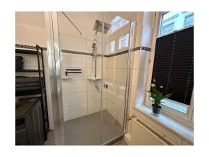 a shower with a glass door in a bathroom at Family apartment at Pfaffenteich in Schwerin