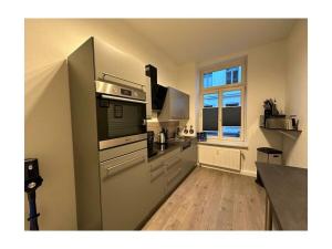 a large kitchen with a stove and a window at Family apartment at Pfaffenteich in Schwerin
