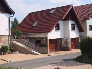 a house with a red roof and stairs at in the Oertel holiday home 