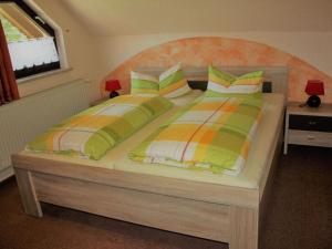 a bedroom with a large bed with colorful pillows at in the Oertel holiday home 