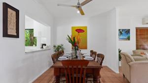 a dining room with a table and chairs at 51 Reef Street Port Douglas in Port Douglas +16 photos